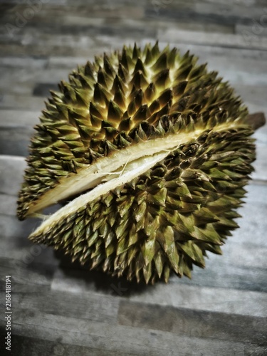 Photography Whole Ripe Durian Fruit Split Open with Sharp Thorns on Wooden Surface, Tropical