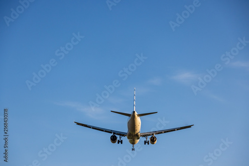 View of a commercial airliner with landing gear extended approaching Vilnius International Airport in Vilnius, Vilniaus apskritis, Lithuania.
