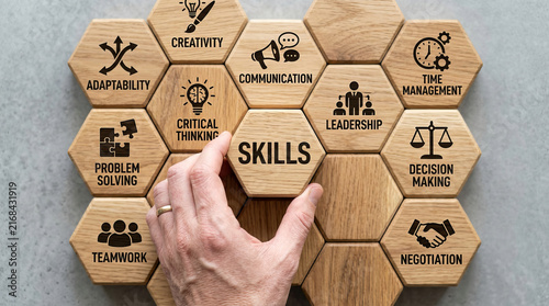 Professional soft skills development and career growth concept with a hand placing wooden hexagon blocks.