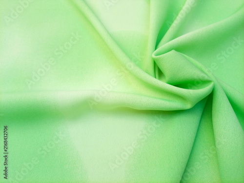 Light green pastel with a subtle gradient abstract swirled fabric texture or textile background. Soft and calming background for websites, banners, or graphic design projects.