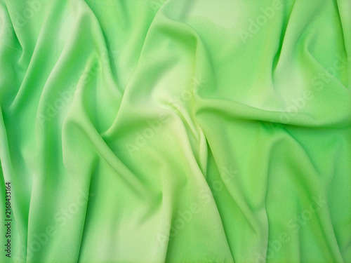 Light green pastel with a subtle gradient abstract wavy fabric texture or textile background. Soft and calming background for websites, banners, or graphic design projects