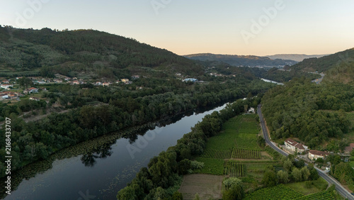 Mino river flowing through vineyards and hills in Galicia