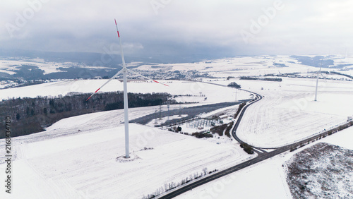 Фотография Windless wind turbine in snow, dark doldrums or wind lull in winter, renewable s