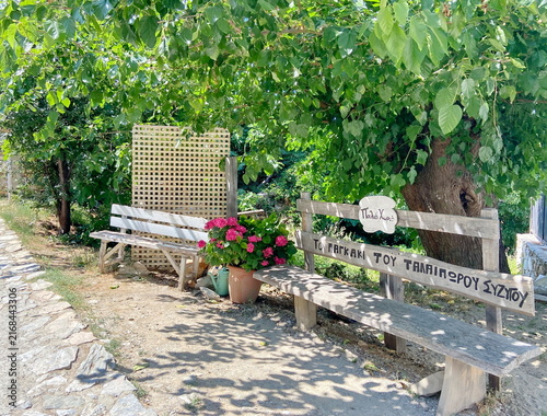 Obraz na płótnie The mountain village of Paleos Panteleimonas on the slope of Mount Olympus with a bench with the inscription For the unfortunate husband