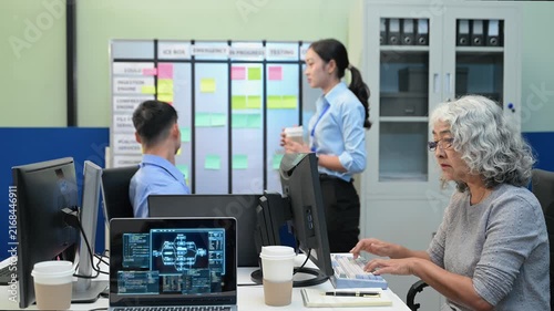 Asian software developers and engineers planning workflow on an agile scrum board with sticky notes