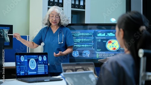Senior doctor explains MRI brain scan results to a diverse medical team in a high tech hospital