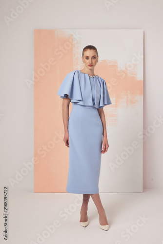 Fotografía Caucasian female model in pale blue midi dress with ruffled cape bodice