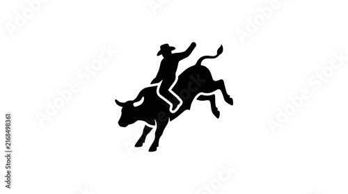 Silhouette of a cowboy riding a bucking bull.