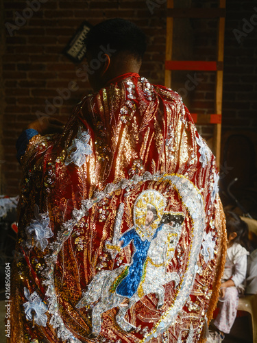Angahuan, Mexico - 24 July 2026: View of a person wearing an ornate, sequined red cape featuring an embroidered depiction of Saint James on horseback, part of the traditional Moros y Cristianos dance.