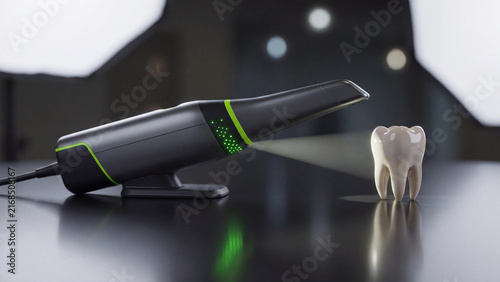 Dental scanner device emitting light toward a single molar tooth mockup on a dark reflective laboratory tabletop.