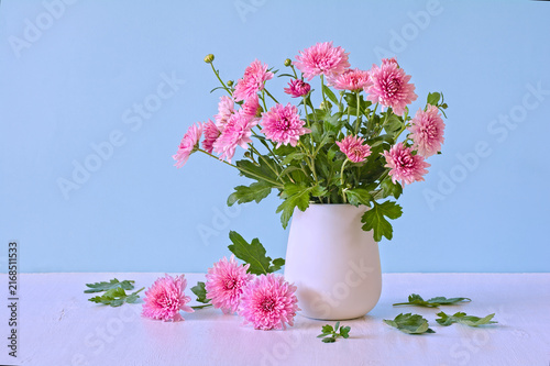 Pink and Lilac Chrysanthemum Bouquet in White Vase on Blue Background