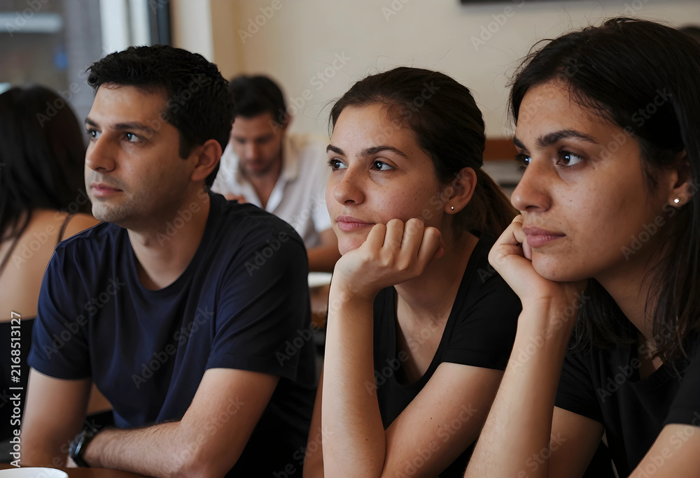 Obraz premium Engaged audience learning and development, diverse group of young adults listening attentively in a classroom or seminar setting