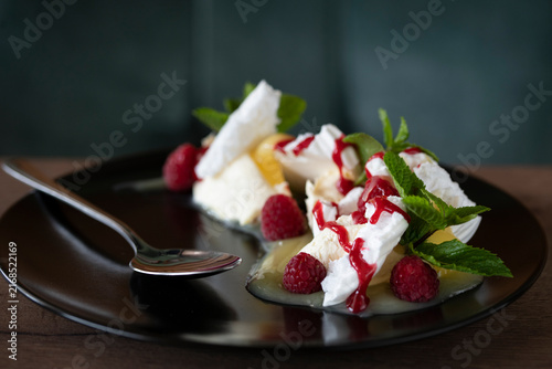 Cuadro en lienzo Delightful Dessert With Whipped Cream, Fresh Raspberries, and Mint on a Stylish