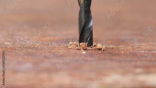 Close-Up Drill Bit Boring Into Wood Surface	