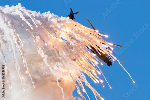 Canvastavla Military helicopter dropping flares during tactical maneuver