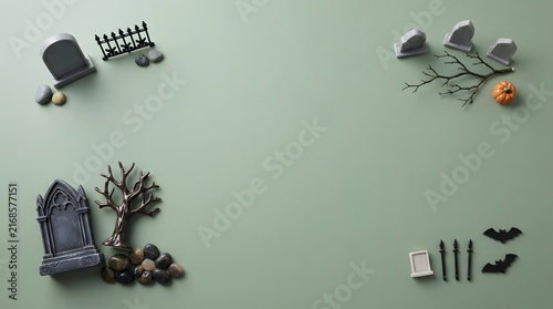 Halloween flat lay background with miniature tombstones trees and bats on a muted green surface