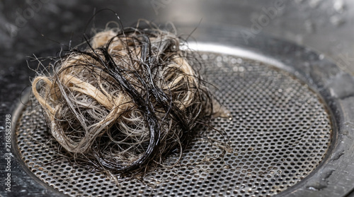 Hair and fiber mat clump on stainless steel drain screen 