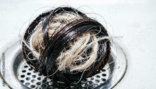 Hair and fiber mat clump on stainless steel drain screen 
