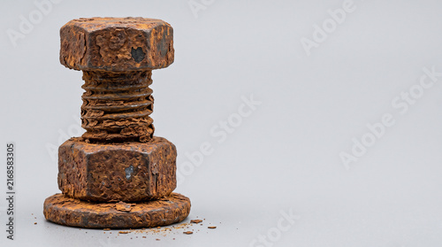 Heavily corroded steel flange bolt with flaking rust macro 