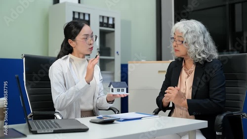 Car insurance consultation using smartphone and documents. Advisor and customer reviewing digital insurance service, auto policy, finance