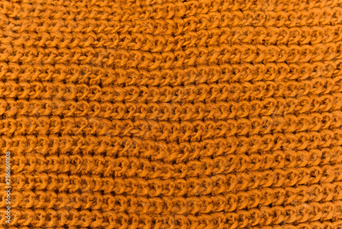 Close view of a knitted scarf showing details of the texture and color