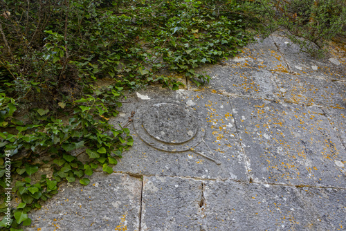 A symbol carved into the stone in an ancient city in the mountains. Termessos is an ancient city located in Turkey. Erosion on the stone. Traces of an ancient civilization.