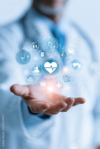 Doctor's hand displaying glowing medical icons and digital health concept
