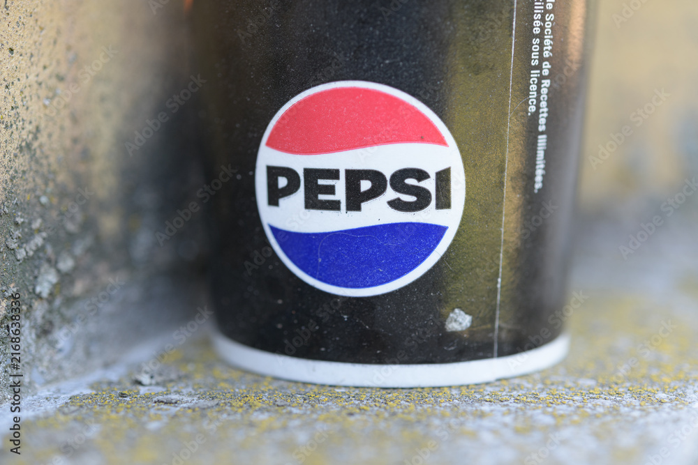 Obraz premium detail of a discarded beverage cup with circular red, white, and blue emblem of the Pepsi Globe; bold brand name, Toronto