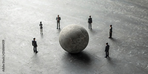Business Team Standing Around a Large Sphere on Concrete Floor – Leadership, Strategy and Teamwork Concept