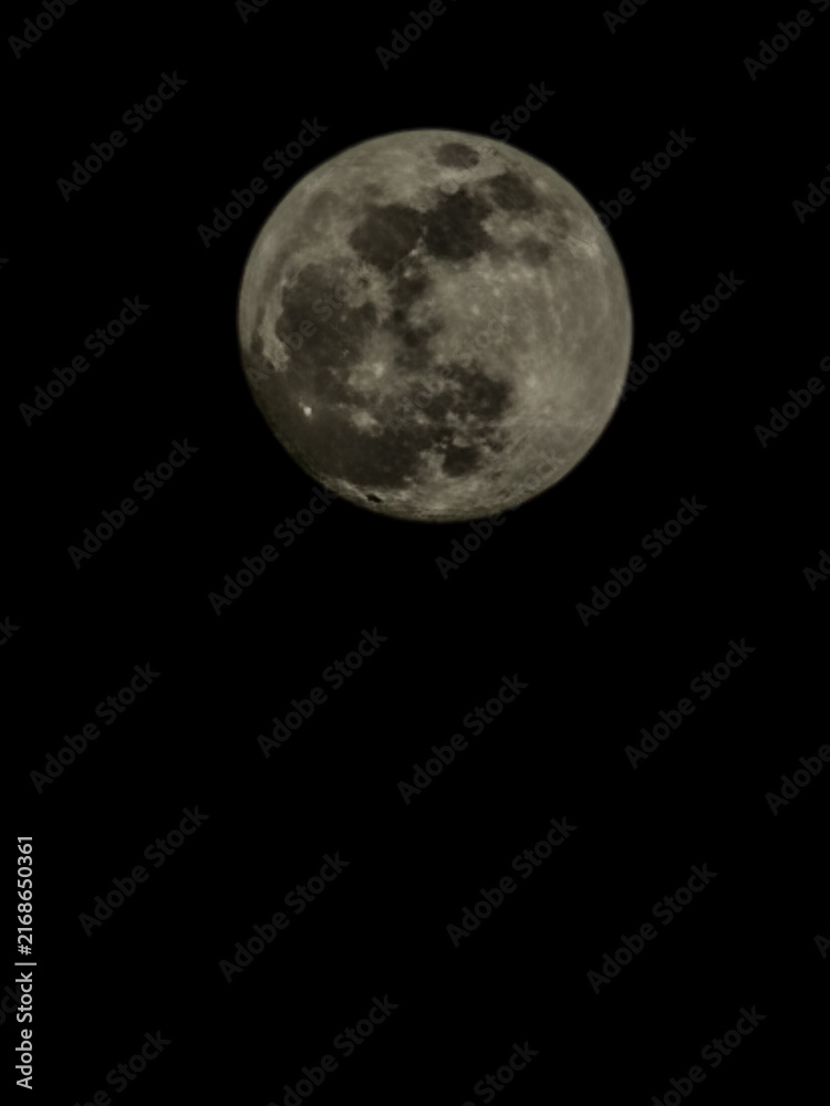 Fototapeta premium Full moon against a black night sky