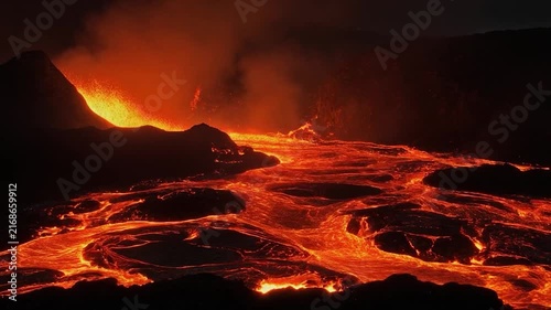 Fiery Lava Flowing Down Volcano Slope at Night.