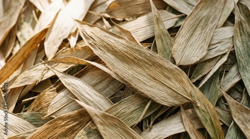 Dried Bamboo Leaf Texture: A close-up, overhead view reveals the intricate, dry texture of numerous bamboo leaves, showcasing natural patterns and subtle color variations.