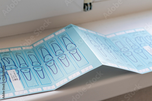 Fotografía Dental Implant Tooth Numbering Guide and Tracking Chart Opened on White Windowsill Surface