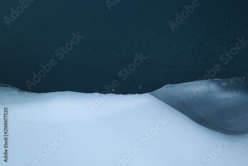 Abstract aerial view of frozen lake and snow forming natural winter patterns