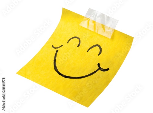 Yellow paper note with happy smile illustration. Good mood and mental health concept. Taped memo sheet displaying cheerful hand drawn face