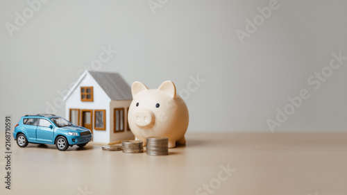 Home, car, piggy bank, and coins form a household asset scene, illustrating property insurance, mortgage planning, and balanced investment. Personal assets, finance; personal focus.