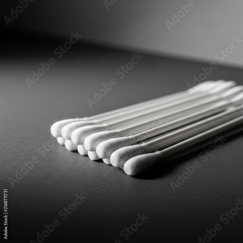 Neatly Arranged Sterile Cotton Swabs in a Studio Setting with a Dark, Clean Background