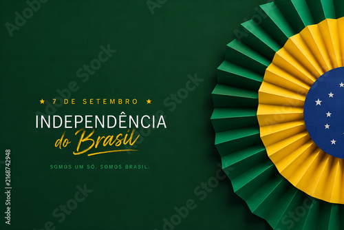 Brazilian independence day celebration featuring a decorative paper fan with green yellow and blue colors on a dark background surface