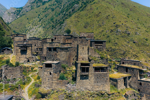 Aerial view of the historic stone towers and fortifications of Shatili village nestled in the mountains, featuring traditional medieval architecture in Shatili, Mtskheta-Mtianeti, Georgia.