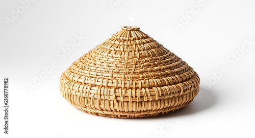 Handwoven rattan food cover, traditional conical basket dome for dining table, isolated on white background