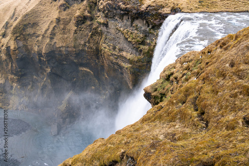 The Skogaa River cascading down the rock to form the Skogafoss waterfall in southern Iceland on a cloudy day in March.