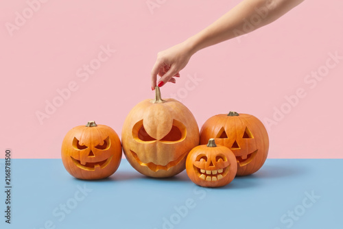 Hand touching Halloween pumpkins