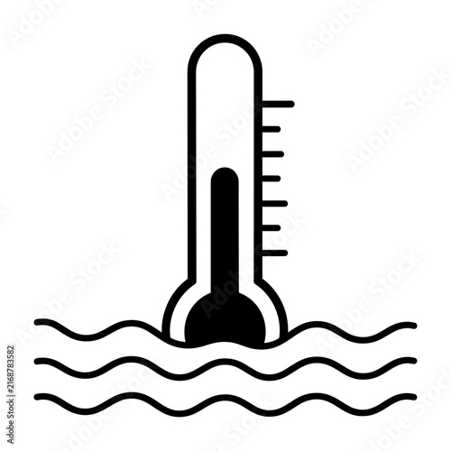 Thermometer partially submerged in water illustrates temperature measurement in a scientific or environmental context.