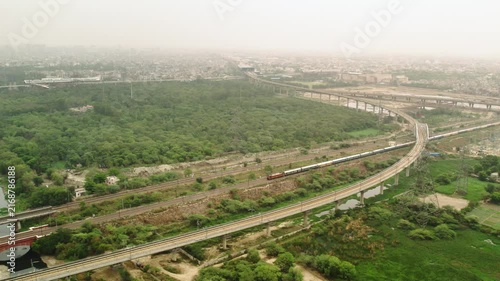 Aerial view of expressway construction and railway tracks in New Delhi, India.