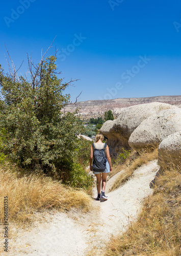 Female hiker explores cappadocia love valley. Concept of summer hiking adventure and freedom.