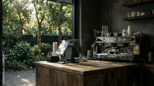 Corner cafe counter featuring a professional espresso machine and a digital tablet for point of sale transactions