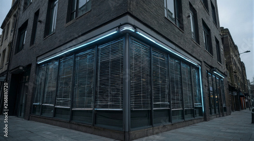 Smart home exterior featuring sleek silver roofline and ambient neon blue climate responsive LED lighting at dusk