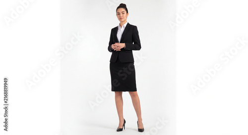 Full body portrait of a young professional woman in a black suit isolated on white background