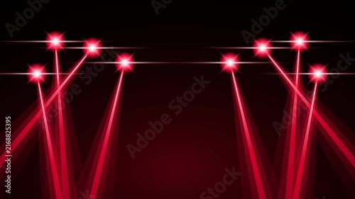 Bright red laser beams shining upward in a dark background for stage show or concert event lighting
