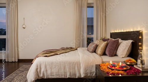 Cozy modern bedroom interior decorated with glowing traditional oil lamps for the beautiful hindu festival of diwali celebration